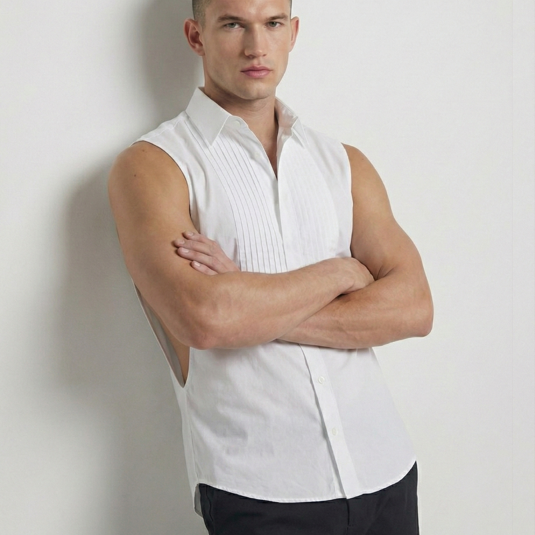 Man wearing a white sleeveless shirt and black pants against a plain background