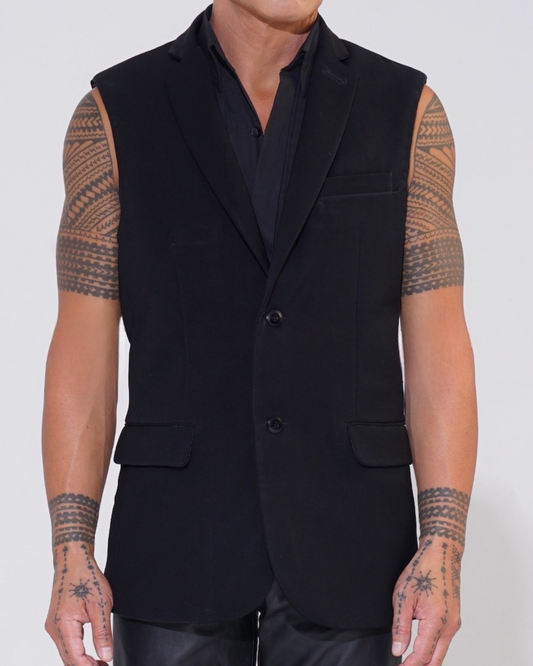Black tailored sleeveless jacket with two-button front on male model with Endemann leather pants and black sleeveless shirt