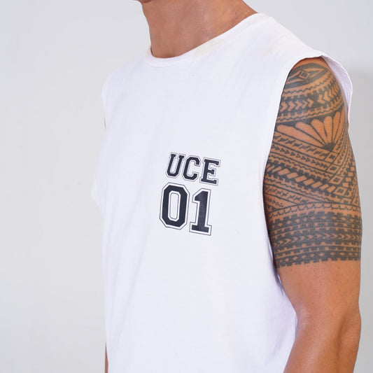Person wearing a white sleeveless shirt with 'UCE 01' text and displaying a tattooed arm.
