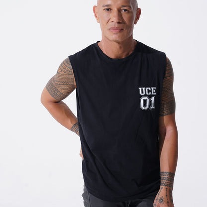 Man wearing a black sleeveless shirt with 'UCE 01' text on a white background